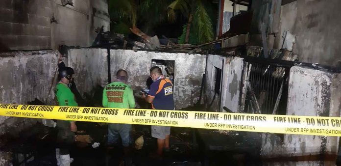 Firefighters secure the area where a blaze broke out in Barangay Calaparan, Arevalo, Iloilo City on Saturday, May 22, 2022. A house was totally gutted while one was damaged. JAP FAJARDO/PN