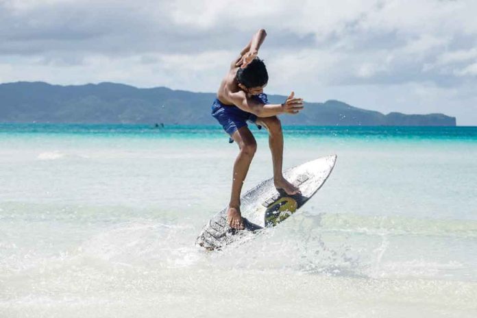 A boy surfs on the waters of the world-famous Boracay Island in Malay, Aklan. The national government is willing to work with the local government unit to boost the country’s “tourism jewel”, according to Anthony Gerard Gonzales, undersecretary of the Office of the Presidential Assistant for the Visayas.