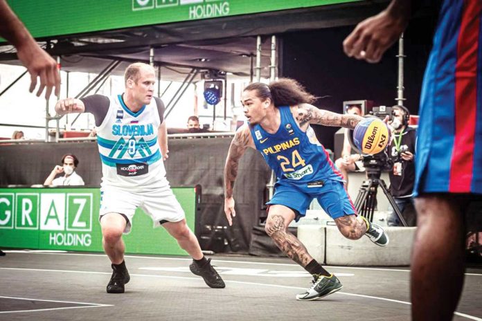 Gilas Pilipinas 3x3’s Joshua Munzon attempts to evade Slovenia’s defense during their basketball match in the 2021 FIBA 3×3 Olympic Qualifying Tournament in Austria. FIBA