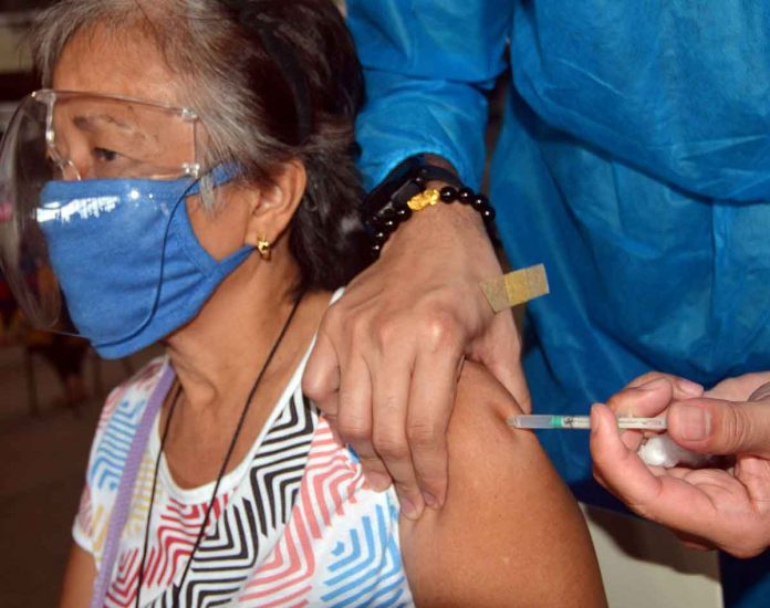 VACCINATION COMPLETE. An elderly woman gets her second dose of the Sinovac COVID-19 vaccine at the Pasay City West High School. More Filipinos are expected to be vaccinated with the arrival of more COVID-19 vaccine supplies in the coming months. PNA