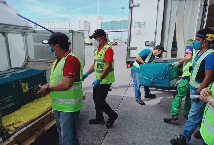 Personnel of the Provincial Incident Management Team of Negros Occidental facilitate the offloading of the 3,080 vials of the AstraZeneca vaccines delivered to the province yesterday. IMT NEGROS OCC