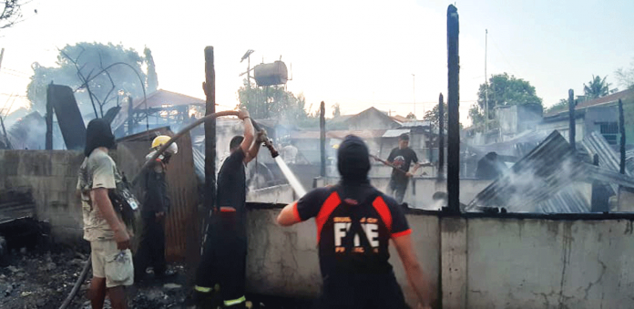 Firefighters put out the blaze that gutted two houses on Armada Street, Barangay Poblacion, Janiuay, Iloilo on April 30. JAP FAJARDO/PN