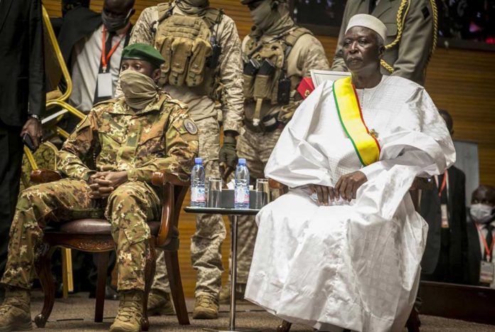 In this file photo, retired Colonel Major Bah N'Daw (right) is sworn into the office of transitional president at a ceremony in Bamako, Mali. Mali's military has released the transitional president and Prime Minister Moctar Ouane from detention on Thursday after they resigned from their respective posts. AP