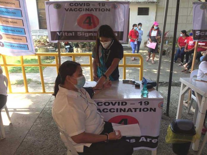 A frontliner gets her vital signs checked prior to vaccination against coronavirus in this vaccination center of Jorda, Guimaras. PHOTO FROM THE FACEBOOK PAGE OF MAYOR RUBEN CORPUZ