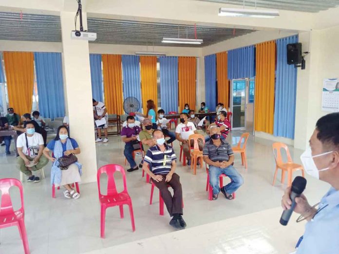 Mayor Eugenio Reyes of Buenavista, Guimaras and Dr. Grace Cortez, municipal health officer, discuss with barangay captains new health protocols. Photo from Buenavista LGU