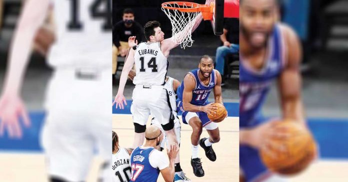 New York Knicks' Alec Burks (18) passes away from San Antonio Spurs' Drew Eubanks (14) during the second half of an NBA basketball game in New York. PHOTO BY: AP PHOTO/FRANK FRANKLIN II, POOL