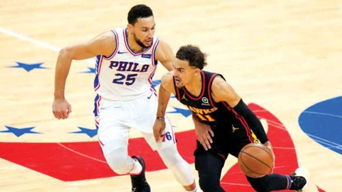 Atlanta Hawks’ Trae Young (11) attacks the defense of Philadelphia 76ers' Ben Simmons (25) during their Game 7 match on Sunday. The Hawks tallied 103-96 to advance to the Eastern Conference finals. AP