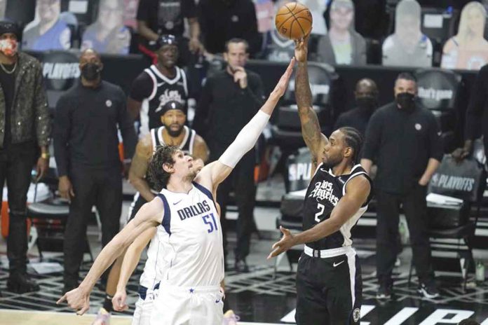 Dallas Mavericks’ Boban Marjanovic (51) defends against Los Angeles Clippers’ Kawhi Leonard (2) during the do-or-die Game 7 of their NBA first-round series on Sunday. AP/ASHLEY LANDIS