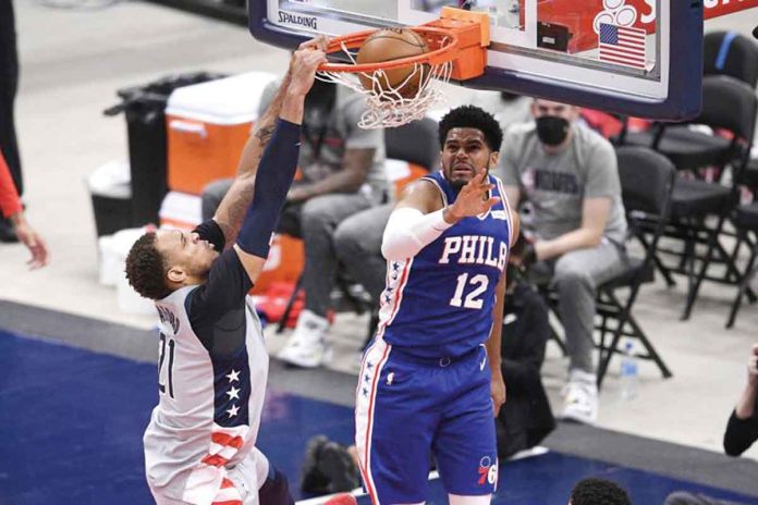 Washington Wizards’ Daniel Gafford (21) dunks against Philadelphia 76ers’ Tobias Harris (12) during the second half of Game 4 of the NBA Eastern Conference first-round playoffs series on Monday. AP PHOTO/NICK WASS