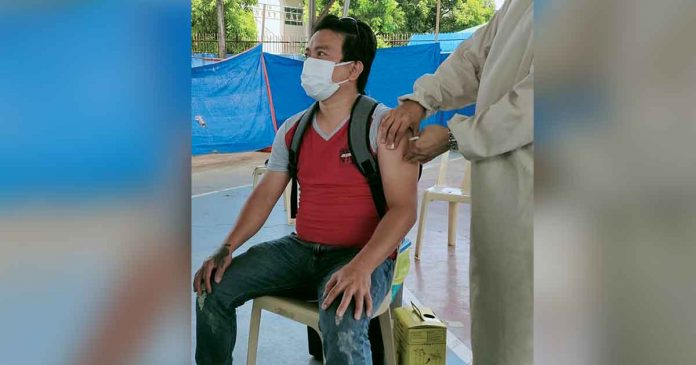 Residents of Bugasong, Antique, like 35-year-old Rian Villabueva receive their first dose of the COVID-19 vaccine. Around 1,000 Bugasongnons have been inoculated as of June 23. RHU-BUGASONG/FB