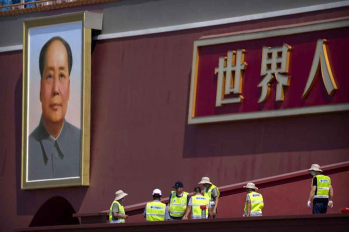 Workers prepare a raised seating area near the large portrait of Chinese leader Mao Zedong on Tiananmen Gate near Tiananmen Square in Beijing, China. AP PHOTO/MARK SCHIEFELBEIN