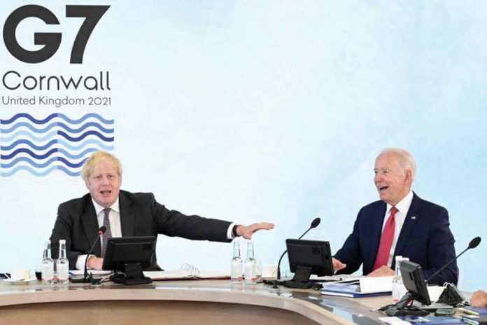 United States President Joe Biden (right) and Britain's Prime Minister Boris Johnson (left) attend a working session during G7 summit in Carbis Bay, Cornwall in Britain, June 12, 2021. LEON NEAL/POOL VIA REUTERS