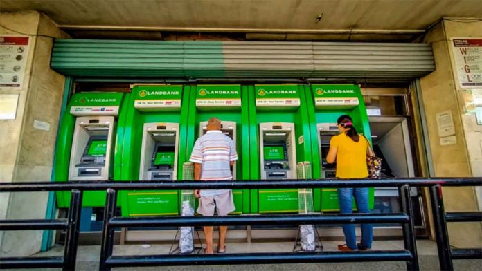 People transact at a bank’s automated teller machine terminal on Solis Street, Iloilo City. A panel of House lawmakers have approved House Bill 7619 or the “Bank Account Portability for Workers Act,” which allows private sector employees to choose the bank account where their wages may be deposited. PN FILE PHOTO