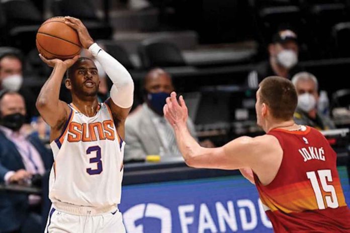 Phoenix Suns' Chris Paul (3) goes for a three-point shot against Denver Nuggets' Nikola Jokić (15) during Game 4 of the Western Conference semifinals on Sunday. Phoenix scored 125-118 to sweep the series. GETTY IMAGES