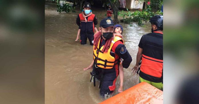 Responders rescue children from rising floodwaters in President Roxas, Capiz on Wednesday morning. OPFM CAPIZ BFP