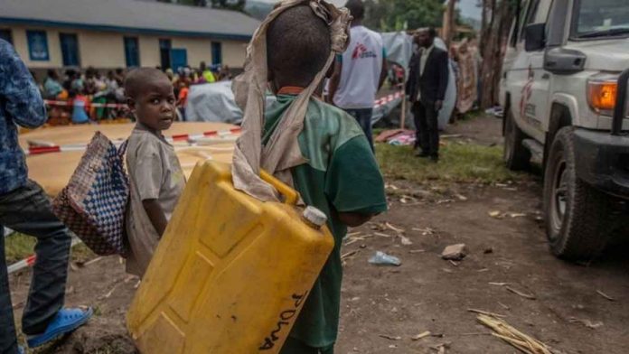 Displaced people – including children – are queuing to get drinking water at a temporary camp in Sake in the Democratic Republic of Congo. REUTERS