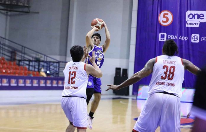 Kiefer Ravena of NLEX Road Warriors attempts for a basket while Barangay Ginebra San Miguel Kings’ Prince Caperal (12) defends during their PBA Philippine Cup match on Sunday at the Ynares Sports Arena in Pasig City. PBA MEDIA BUREAU