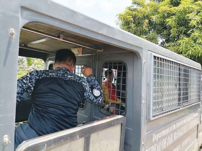 Jail escapee Daniel Tamon sits inside a Bureau of Jail Management and Penology vehicle shortly after his recapture on June 30 at Hacienda Velez in Barangay Blumentritt, Murcia, Negros Occidental. DOMINIQUE GABRIEL BAÑAGA/PN