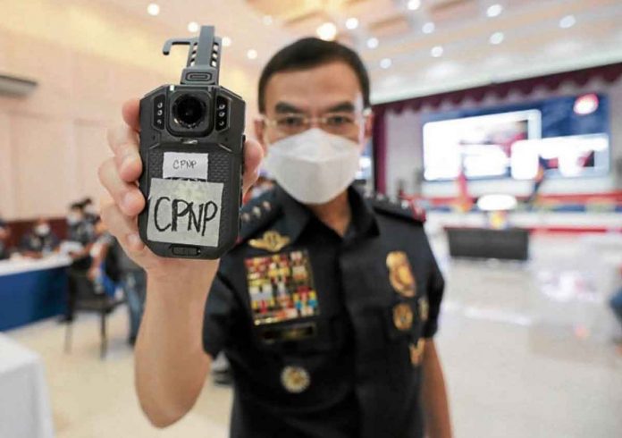 Philippine National Police Chief General Guillermo Eleazar, shows the Body-Worn Camera System during its launching at a press conference on Friday, June 4, 2021, at Camp Crame in Quezon City. INQUIRER PHOTO/GRIG C. MONTEGRANDE