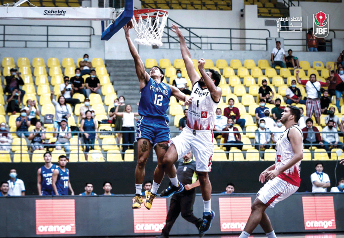 Ilonggo Ferdinand Ravena III (12) of Gilas Pilipinas drives for a basket against the defense of Egypt during their 2021 King Abdullah Cup game on Monday in Jordan. JORDAN BASKETBALL FEDERATION