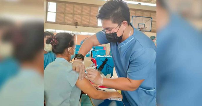 A healthcare worker gives a resident of Iloilo City a vaccine against coronavirus disease 2019 (COVID-19) at the gym of Ateneo de Iloilo in Mandurriao district. The school is one of the vaccination sites of the city government. JAPHET FAJARDO/PN