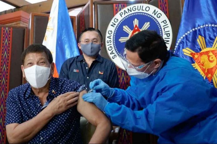 President Rodrigo Duterte receives his second dose of the Sinopharm COVID-19 vaccine administered by Health Secretary Francisco Duque III. SENATOR BONG GO