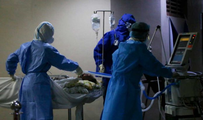 A COVID-19 patient on a mechanical respirator is wheeled out by health personnel to another room for dialysis treatment in UP-Philippine General Hospital, Manila. INQUIRER PHOTO/LYN RILLON