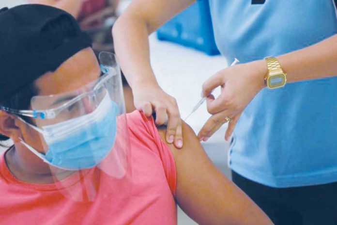 A frontliner belonging to the A1 priority group receives a COVID-19 vaccine. CITY OF SAN FERNANDO INFORMATION OFFICE VIA INQUIRER