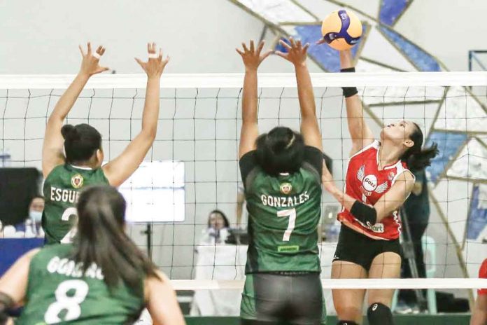 Petro Gazz Angels’ Gretchel Soltones (right) attacks the defense of Black Mamba-Army Lady Troopers during their volleyball game on Sunday. PVL MEDIA BUREAU