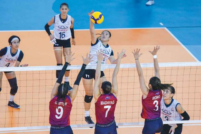 Ma. Shaya Adorador of Chery Tiggo Crossovers (11) unloads a drop shot against the triple-block defense of Pauline Gaston, Madeleine Madayag, and Deanna Wong of Choco Mucho Flying Titans during Game 2 of the Premier Volleyball League Open Conference semifinals on Monday at Bacarra, Ilocos Norte. PVL MEDIA BUREAU