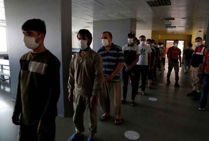 Migrants, mostly from Afghanistan, wait in line for lunch at a repatriation center in the border city of Van, Turkey, on Monday. REUTERS/MURAD SEZER