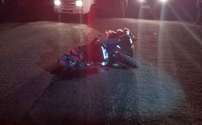 A motorist lies wounded on Palanca Street, Barangay 10, Bacolod City after he was shot by unidentified riding-in-tandem gunmen. POLICE STATION 2/BCPO