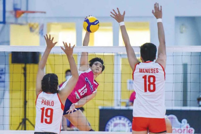 Creamline Cool Smashers’ Diana Carlos (center) drops the ball between Petro Gazz Angels’ Myla Pablo (19) and Marivic Meneses (18) during the 2021 Premier Volleyball League Open Conference semifinals on Sunday in Bacarra, Ilocos Norte. PVL MEDIA BUREAU