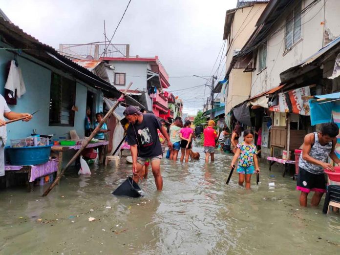 Residents of all ages wade in the floodwaters in Barangay Rizal Pala-pala 2, Iloilo City. All the 180 barangays in this city are susceptible to flooding, according to the Mines and Geosciences Bureau in Region 6. PANAY NEWS PHOTO