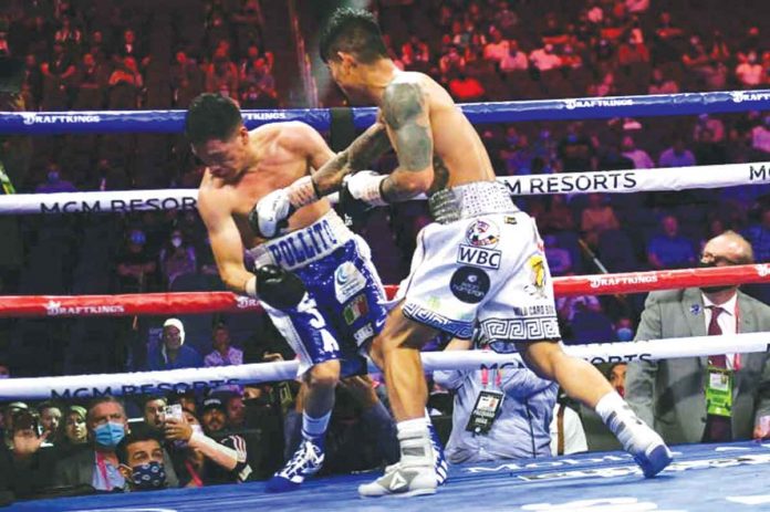 Mark Magsayo (right) of the Philippines hits Julio Ceja of Mexico with a knockout punch during their WBC featherweight championship bout at the T-Mobile Arena in Las Vegas, Nevada on August 21, 2021. Magsayo knocked out his opponent to improve his boxing record to 23-0-0. AFP