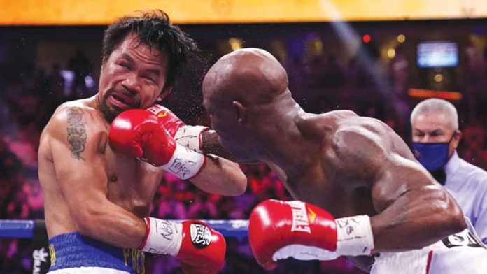 Cuban fighter Yordenis Ugas unloads a solid right punch straight to the face of Filipino boxer Manny Pacquiao during their WBA welterweight championship clash on Saturday night (Sunday in the Philippines). AP