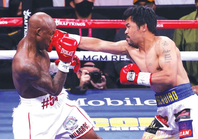 Manny Pacquiao (right) attacks Yordenis Ugas with a right straight punch to the face during their world welterweight championship bout. Despite failing to reclaim his WBA title, the Filipino boxer stated that a rematch with the Cuban slugger in January next year is possible. AFP