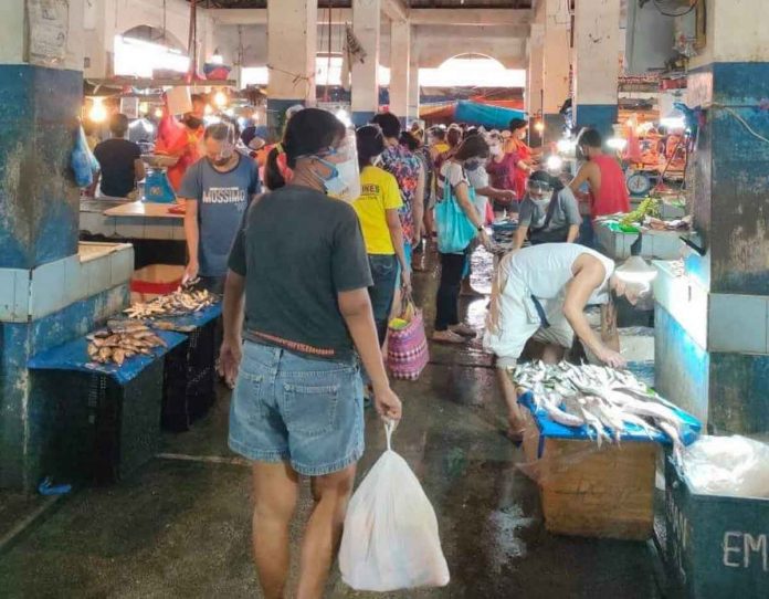 People wear facemask and face shield at the public market of Kalibo, Aklan. The coronavirus risk level classification of Aklan has been downgraded to moderate risk.