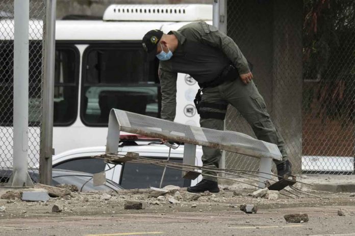 A police officer inspects damage at a police station after a bomb exploded in Cucuta, Colombia, on Monday. AP/FERLEY OSPINA