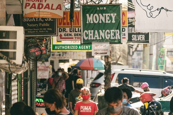 According to the National Economic and Development Authority, the coronavirus disease 2019 restrictions will continue to wreak havoc on the Philippine economy for the next four decades, with estimated losses amounting to a whopping P41.4 trillion. Photo shows people wearing facemasks passing through one of Iloilo City’s busiest areas, the Downtown district.. Photo courtesy of JAMES RHOY ESPERO