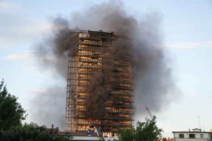 Smoke billows from a building in Milan, Italy, on Sunday. Firefighters were battling a blaze that spread rapidly through a recently restructured 60-meter-high, 16-storey residential building. There were no immediate reports of injuries or deaths. AP/LUCA BRUNO