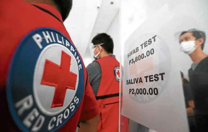 People taking COVID-19 tests at the Philippine Red Cross may now submit their saliva as specimen as the agency launches in January a cheaper alternative to the reverse transcription polymerase chain reaction testing through swabbing. INQUIRER/NIÑO JESUS ORBETA