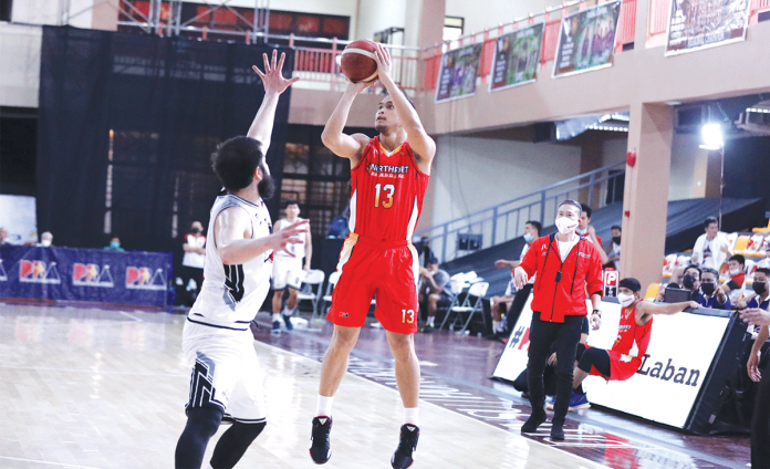 Garvo Lanete of NorthPort Batang Pier (13) attempts to score over the outstretched arms of Andre Paras of Blackwater Bossing during Thursday's PBA Philippine Cup match. Batang Pier made a triumphant return after a 98-73 victory against the Bossing. PBA