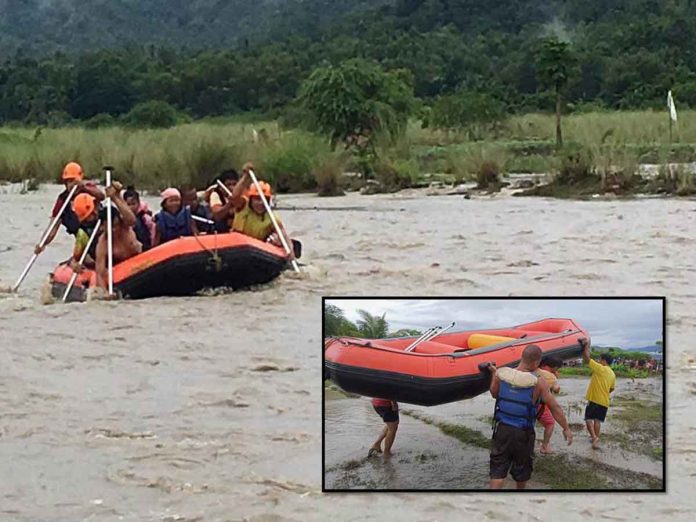 Rescuers use an inflatable rubber boat to secure two women when the water level of the Cangaranan River in Barangay Canipayan, Valderrama, Antique suddenly rose on Sept. 8, 2021. PHOTOS BY ANTIQUE PDRRMO AND VALDERRAMA MDRRMO