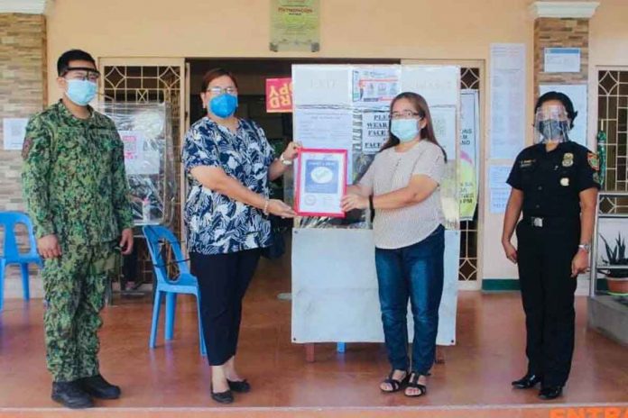 Mayor Evohn Nee Baldestamon of Patnongon, Antique receives the town’s Safety Seal certificate from the Department of Interior and Local Government .