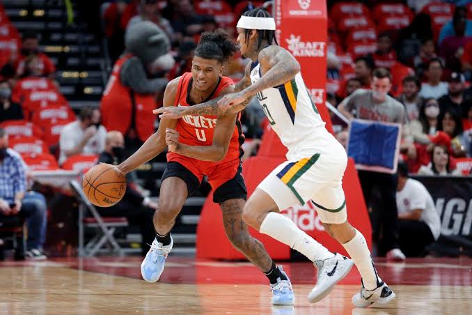 Houston Rockets guard Jalen Green (0) drives under pressure from Utah Jazz guard Jordan Clarkson (right), during their NBA basketball game on Oct. 28, 2021 in Houston. PHOTO BY MICHAEL WYKE, ASSOCIATED PRESS