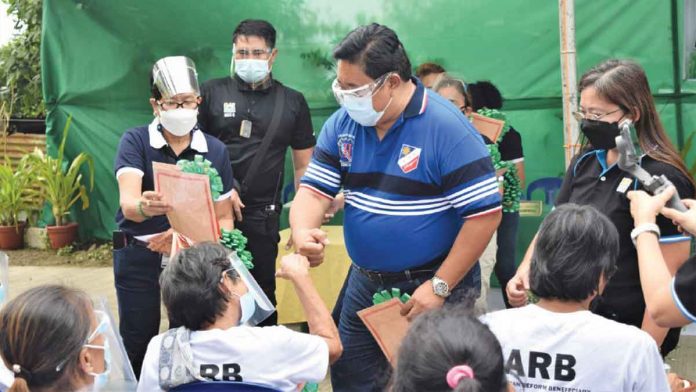 Department of Agrarian Reform Secretary, Atty. Bro. John R. Castriciones administers the distribution of Certificates of Land Ownership Award.