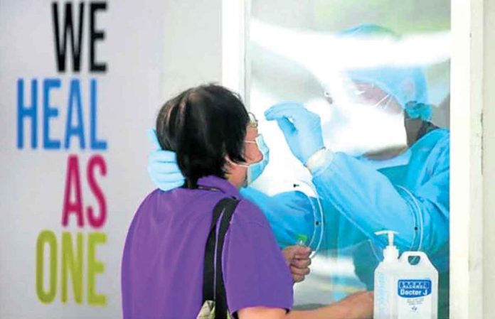 Persons identified for contact tracing in connection to COVID-19 patients undergo swabbing procedures inside UP-Philippine General Hospital, Manila. INQUIRER PHOTO/LYN RILLON