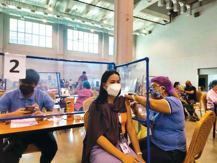 An eligible resident receives a Pfizer shot at the Iloilo Convention Center in Mandurriao, Iloilo City. PANAY NEWS PHOTO