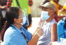 A healthcare worker prepares a coronavirus disease 2019 vaccine prior to inoculation in Barangay M.V. Hechanova, Jaro, Iloilo City. The city COVID team attributes the decline in coronavirus cases in the metropolis to its high vaccination rate. CMO PHOTO